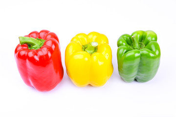 red, green and yellow paprika on a white screen
