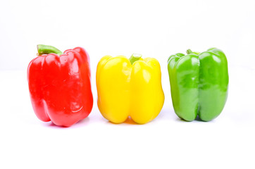 red, green and yellow paprika on a white screen