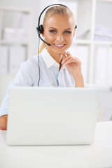 Portrait of beautiful businesswoman working at her desk with he