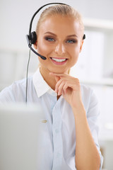 Portrait of beautiful businesswoman working at her desk with he