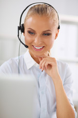 Portrait of beautiful businesswoman working at her desk with he