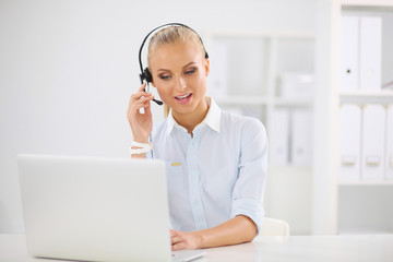 Portrait of beautiful businesswoman working at her desk with he