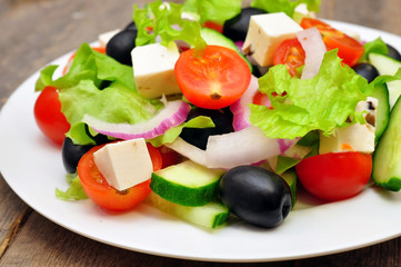 Greek salad on a wooden table