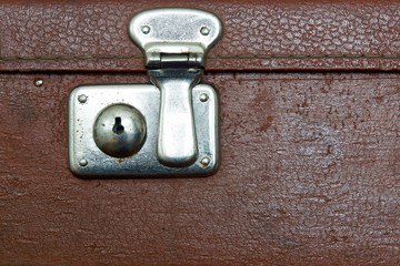 closed lock of an old suitcase dark brown color © malven
