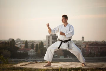 Fotobehang Man practicing martial arts outdoors © bokan