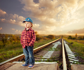 stylish countryside boy at railway sunset