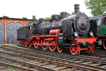 Old steam locomotive on railroad.