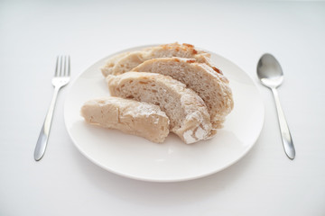 Bread served on white table with utensils