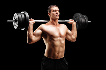 Naklejka na ściany i meble Weightlifting athlete lifting a barbell