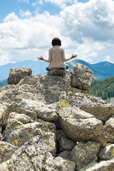 Obraz premium Girl in meditation on Dolomiti - Italy