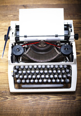Typewriter and a blank sheet of paper