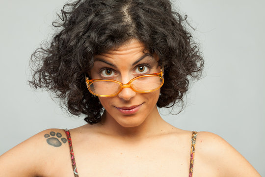 Surprised sexy brunette with orange glasses