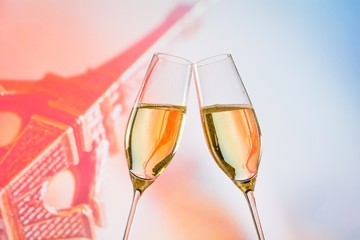 champagne flutes with golden bubbles on blur background