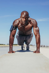 Shirtless young man doing push-ups