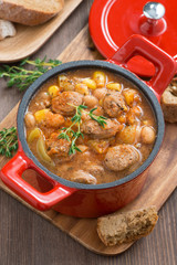 delicious vegetable stew with sausages in a pan, top view