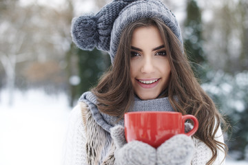 Warming up of gorgeous young woman in winter