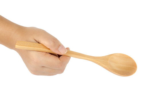 Woman's Hand Holding Wooden Spoon