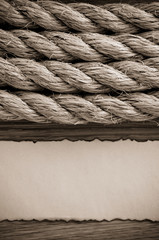 Fototapeta na wymiar ropes and old paper at wood