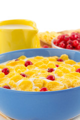 corn flakes and milk in bowl on white