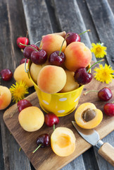 Fresh apricot and cherry in a bucket