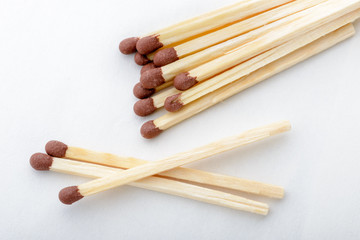 Close-up of matches on white paper background