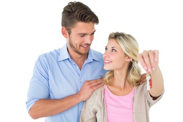 Attractive young couple showing new house key