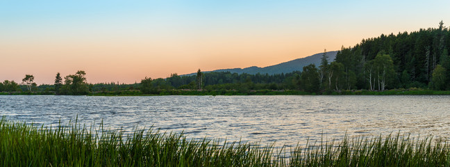 Panorama of a small lake at dusk