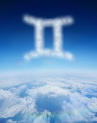 Composite image of cloud in shape of gemini star sign