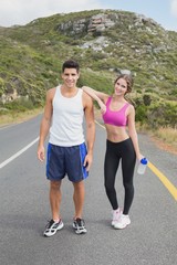 Portrait of a fit couple standing on road