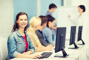 smiling teenage girl with classmates and teacher