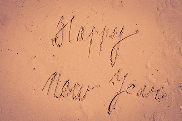 Happy New Year written into sand