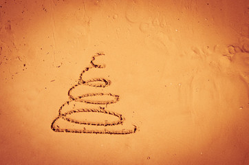 Christmas tree drawn into sand