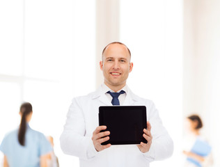 smiling male doctor with tablet pc