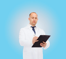 Obraz na płótnie Canvas serious male doctor with clipboard