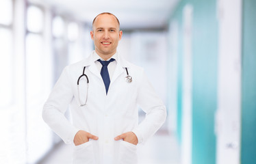 smiling male doctor in white coat with stethoscope