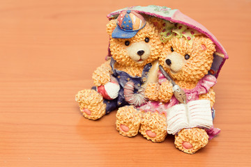 ceramic bear together under umbrella