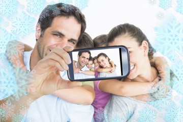 Composite image of hand holding smartphone