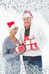 Festive mature couple in winter clothes with packets