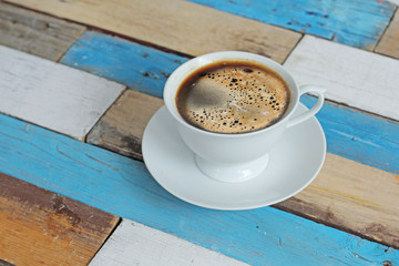 coffee served in a white cup on wooden table
