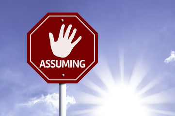 Stop Assuming red sign with sun background