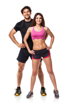 Athletic couple - man and woman after fitness exercise on white