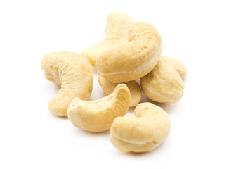 cashew nuts in a wooden bowl isolated on white