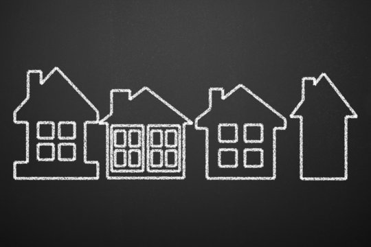 Hand Drawing Houses on the blackboard