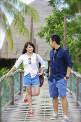 Beautiful married couple on the wooden bridge.