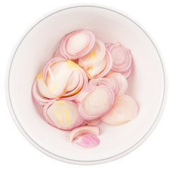 Obraz na płótnie Canvas Chopped onions in a bowl over white background