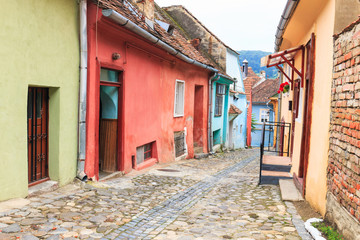 Fototapeta na wymiar Medieval street view in Sighisoara founded by saxon colonists in