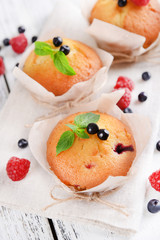 Tasty cupcakes with fruits on table close-up
