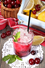 Fresh cold cherry cocktail with mint, ice and lemon