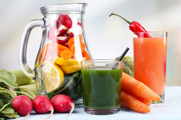 Jar of cut vegetables and glass of fresh vegetable juice with