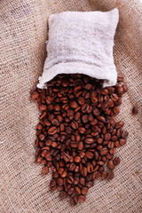 Coffee beans on sacking background